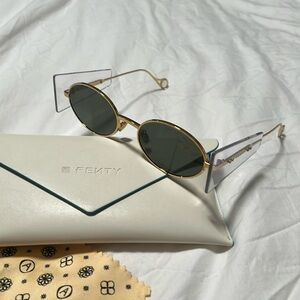 Fenty modern sunglasses!! Side visors, gold tone frames, dark green lenses.
